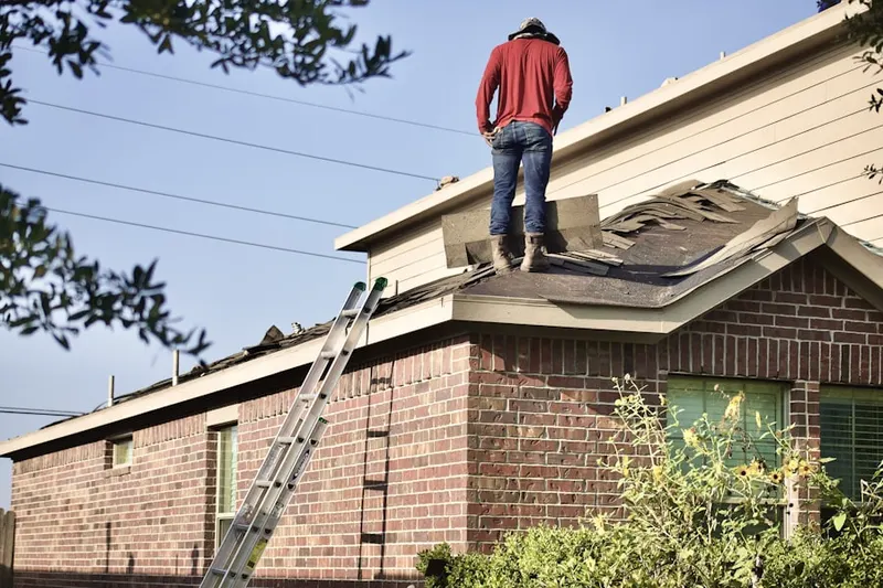 Professional roofer working on a residential roof in Harpers Choice